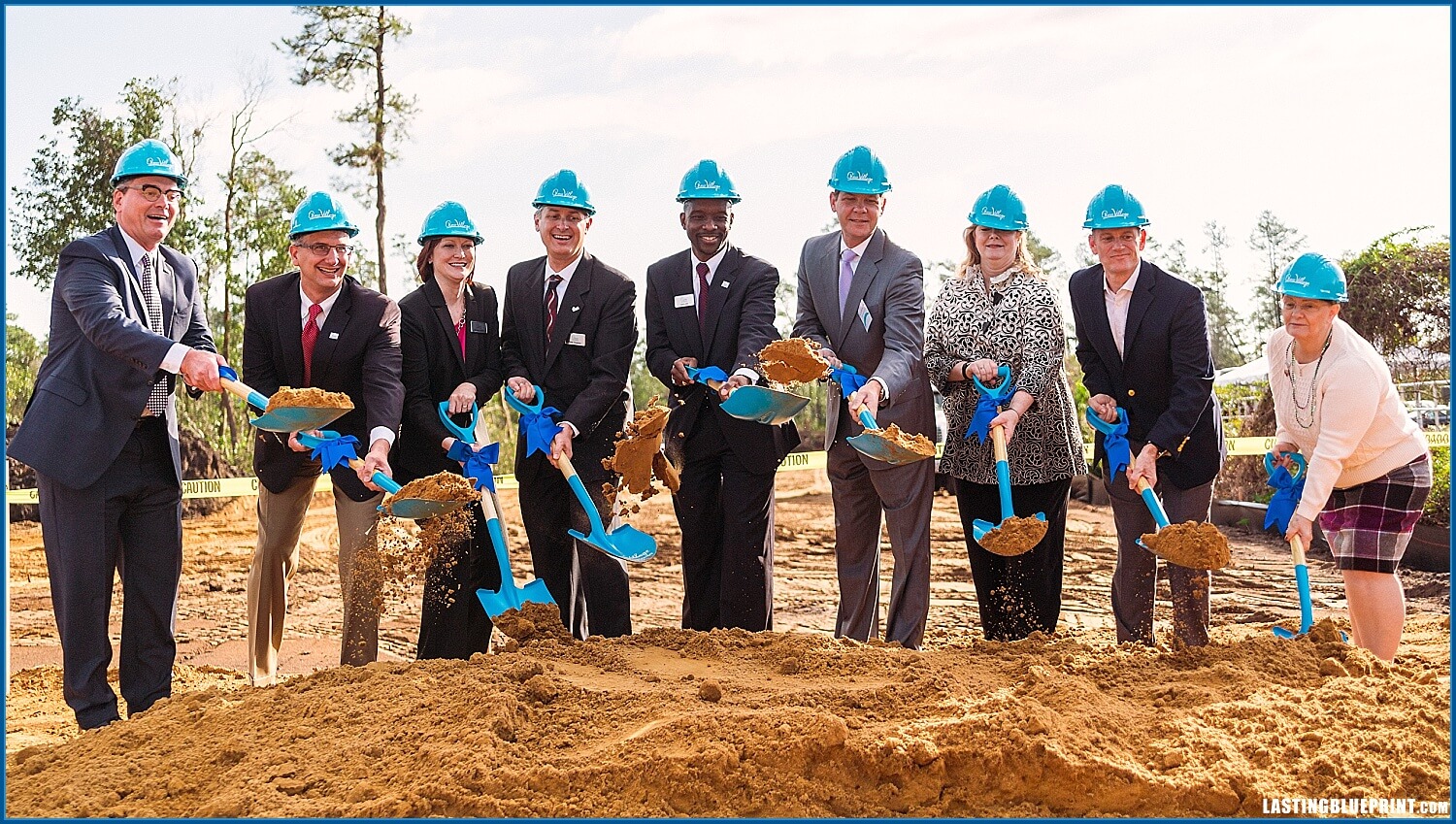 Orlando event videographer captures a gorup photo at quest village groundbreaking ceremony in orlando